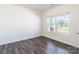 Bedroom with hardwood floors, white walls, and two windows overlooking the front yard at 162 Aspire Cir, Wingate, NC 28174