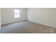 Bedroom with a window for natural light and neutral-colored carpet at 162 Aspire Cir, Wingate, NC 28174