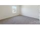 Bedroom with natural light from a window and neutral-colored walls and carpet at 162 Aspire Cir, Wingate, NC 28174