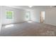 Spacious bedroom featuring windows and neutral-colored carpet at 162 Aspire Cir, Wingate, NC 28174