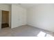 A clean, vacant bedroom with carpet, a closet, and door that faces the hall at 162 Aspire Cir, Wingate, NC 28174