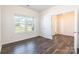 Bedroom with hardwood floors, white walls, and a door leading to another room at 162 Aspire Cir, Wingate, NC 28174