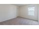 Carpeted bedroom with a door and a single window at 162 Aspire Cir, Wingate, NC 28174