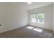 An empty bedroom with neutral carpet and natural light from windows at 162 Aspire Cir, Wingate, NC 28174