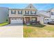 Charming two-story home with a two-car garage, manicured lawn, and covered front porch at 162 Aspire Cir, Wingate, NC 28174