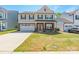 Charming two-story home with a two-car garage, manicured lawn, and covered front porch at 162 Aspire Cir, Wingate, NC 28174