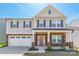 Charming two-story home with a two-car garage, manicured lawn, and covered front porch at 162 Aspire Cir, Wingate, NC 28174