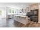 Modern kitchen with gray cabinets, stainless steel appliances, and a large island at 162 Aspire Cir, Wingate, NC 28174