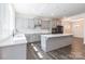 A modern kitchen featuring gray cabinets, stainless steel appliances, and a large center island with white countertops at 162 Aspire Cir, Wingate, NC 28174