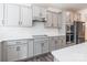 A well-equipped kitchen featuring sleek gray cabinets, white countertops, and modern stainless steel appliances at 162 Aspire Cir, Wingate, NC 28174