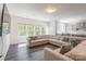 Bright and airy living area featuring large windows, a comfortable sofa, and modern decor at 162 Aspire Cir, Wingate, NC 28174