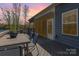 Cozy back deck with dining set and screened-in porch, overlooking lake views, ideal for outdoor relaxation and entertaining at 19650 Harbor Watch Ct, Lancaster, SC 29720