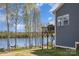 This home features a backyard with a lake view, a firepit, and a wooden deck at 19650 Harbor Watch Ct, Lancaster, SC 29720