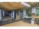 Unfinished basement showing wooden beams, concrete supports, and plywood subflooring at 19650 Harbor Watch Ct, Lancaster, SC 29720