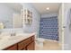 Bathroom with a single sink vanity, toilet and shower with blue patterned curtain at 19650 Harbor Watch Ct, Lancaster, SC 29720