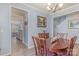 Dining room with wooden table and chairs, chandelier, and doorway view into kitchen at 19650 Harbor Watch Ct, Lancaster, SC 29720