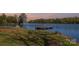 Picturesque dock view along the lake with sunset hues, providing a perfect spot for fishing, boating, or relaxation at 19650 Harbor Watch Ct, Lancaster, SC 29720