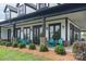 Inviting front porch with blue chairs, landscaping, and modern farmhouse design at 19650 Harbor Watch Ct, Lancaster, SC 29720