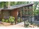Unique building with a stone chimney and expansive screened porch, surrounded by lush landscaping at 19650 Harbor Watch Ct, Lancaster, SC 29720