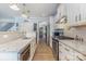 Modern kitchen boasting white cabinetry, granite countertops, and stainless steel appliances at 19650 Harbor Watch Ct, Lancaster, SC 29720
