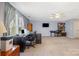 Spacious office featuring large windows, built-in bookshelves, and comfortable furniture at 19650 Harbor Watch Ct, Lancaster, SC 29720