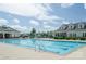 Community pool with clear blue water, clubhouse, and comfortable lounge chairs at 19650 Harbor Watch Ct, Lancaster, SC 29720