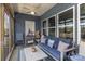 This home has a comfortable screened-in back porch with neutral patio furniture at 19650 Harbor Watch Ct, Lancaster, SC 29720