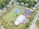 An aerial view shows the community pool, tennis courts, playground, and parking at 202 Weeping Spring Dr, Mooresville, NC 28115