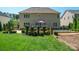 Expansive backyard featuring a well-maintained lawn and a charming patio area, perfect for outdoor relaxation and entertaining at 202 Weeping Spring Dr, Mooresville, NC 28115