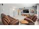 Basement media room with brown leather reclining chairs and a large screen TV for entertaining at 202 Weeping Spring Dr, Mooresville, NC 28115
