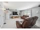 Finished basement media room with a mounted television and comfortable leather seating at 202 Weeping Spring Dr, Mooresville, NC 28115