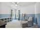 Bright bedroom featuring a chair, ottoman, and natural light with blue accents at 202 Weeping Spring Dr, Mooresville, NC 28115