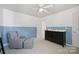 Bedroom features a chair, dresser, and natural light with blue accents at 202 Weeping Spring Dr, Mooresville, NC 28115