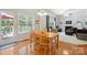 Bright dining area with wood floors, natural light and views into the living room at 202 Weeping Spring Dr, Mooresville, NC 28115
