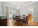 Elegant dining room featuring a wood table, chandelier, and hardwood floors at 202 Weeping Spring Dr, Mooresville, NC 28115