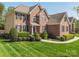 Stunning brick home featuring manicured landscaping, lush green lawn, and classic architectural design at 202 Weeping Spring Dr, Mooresville, NC 28115