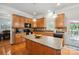 Spacious kitchen featuring wood cabinetry, a central island, and modern appliances at 202 Weeping Spring Dr, Mooresville, NC 28115