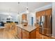 Open-concept kitchen with a large island, stainless steel appliances, and easy access to the living area at 202 Weeping Spring Dr, Mooresville, NC 28115