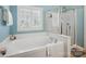 Relaxing main bathroom featuring a soaking tub and a glass-enclosed shower at 202 Weeping Spring Dr, Mooresville, NC 28115