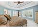 Comfortable main bedroom with natural light, trey ceiling, ceiling fan, and closet at 202 Weeping Spring Dr, Mooresville, NC 28115