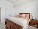 Cozy main bedroom featuring an inviting bed with wooden frame and side tables at 202 Weeping Spring Dr, Mooresville, NC 28115