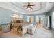 Spacious main bedroom featuring a tray ceiling, ceiling fan, and walk-in closet access at 202 Weeping Spring Dr, Mooresville, NC 28115