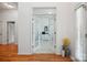 Home office space showcasing hardwood floors and a view of the front foyer, offering a bright and functional workspace at 202 Weeping Spring Dr, Mooresville, NC 28115
