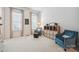 Inviting sitting room featuring plush blue armchairs, natural light from large windows, and stylish decor at 202 Weeping Spring Dr, Mooresville, NC 28115