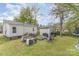 Spacious backyard features a fire pit with seating, a shed, and mature trees, perfect for outdoor activities at 206 Friedheim Rd, Rock Hill, SC 29730