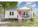 Charming home featuring a pink door, front porch, and landscaped yard at 206 Friedheim Rd, Rock Hill, SC 29730