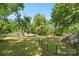 Expansive backyard featuring a fenced area and mature trees perfect for recreation and relaxation at 2115 Fowler Secrest Rd, Monroe, NC 28110