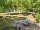 Wooden deck overlooking a lush, well-manicured backyard with mature trees, ideal for outdoor relaxation and dining at 2115 Fowler Secrest Rd, Monroe, NC 28110
