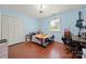 Comfortable bedroom with hardwood floors, closet, a bright window, and personal workspace at 2115 Fowler Secrest Rd, Monroe, NC 28110