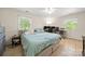 Comfortable bedroom with a large bed, tile flooring, and a workspace featuring multiple monitors at 2115 Fowler Secrest Rd, Monroe, NC 28110
